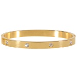 Bracelet jonc rigide en acier doré et cristaux synthétiques.