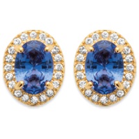 Boucles d'oreilles puces de forme ovale en plaqué or 18 carats pavées d'oxydes de zirconium et surmontées d'une pierre de couleur bleue sertie 4 griffes.
