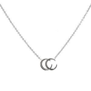 Collier composé d'une chaîne et d'un pendentif formé de deux croissants de lune superposé en acier argenté. Fermoir mousqueton avec 5 cm de rallonge.