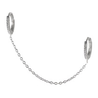 Boucle d'oreille créole en acier argenté pavée de strass reliée par une chaîne à une autre créole pour tragus ou cartilage. Vendu à l'unité.