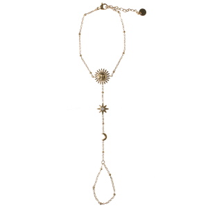 Bracelet de main composé d'une chaîne avec motifs de soleil et croissant de lune en acier doré et d'une étoile ornée d'un cristau serti clos. Fermoir mousqueton avec 3 cm de rallonge.