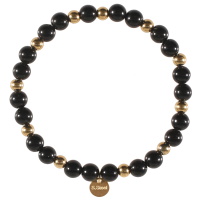 Bracelet élastique composé de perles en acier doré et de perles de couleur noire.