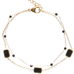 Bracelet double rangs composé d'une chaîne en acier doré avec des perles de couleur noire, ainsi qu'une chaîne en acier doré et des rectangles pavés d'émail de couleur noir. Fermoir mousqueton avec 3 cm de rallonge.
