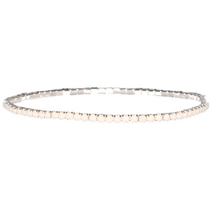 Bracelet fantaisie élastique en métal argenté avec strass de couleur blanc serti griffes.