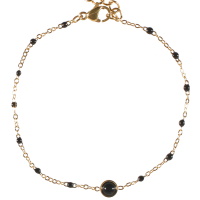 Bracelet composé d'une chaîne en acier doré avec perles en émail de couleur noir et d'un cabochon en véritable pierre d'agate noire. Fermoir mousqueton avec 3 cm de rallonge.