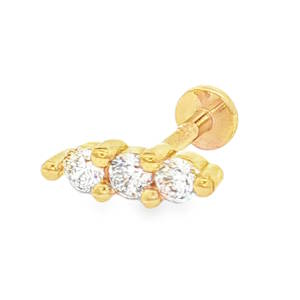 Piercing en acier chirurgical doré serti de trois strass.