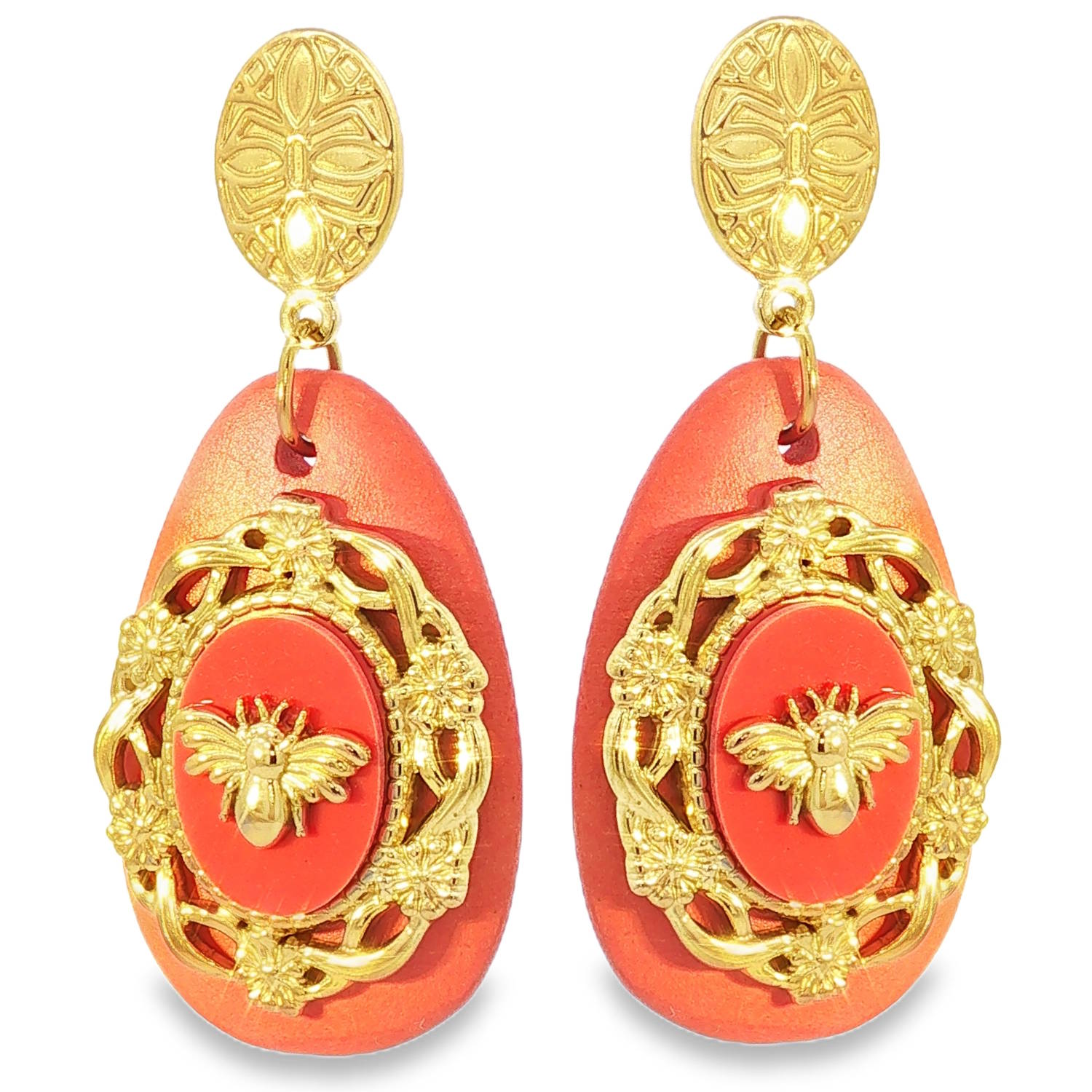 Ces superbes boucles d'oreilles pendantes allient un charme vintage à une esthétique baroque moderne. Conçues en acier inoxydable doré, elles se distinguent par leur robustesse et leur éclat durable.<br/>La puce d'oreille est constituée d'un médaillon ovale en acier doré, finement ciselé avec des motifs géométriques et floraux rappelant l'artisanat antique.<br/>Une imposante goutte d'un orange vibrant sert de base. Sa texture mate et légèrement grainée offre un contraste saisissant avec la brillance du métal.<br/>Au cœur de la goutte se trouve un cabochon ovale entouré d'un cadre doré richement travaillé, orné de fleurs et de volutes. En son centre trône une abeille sculptée en relief, symbole de noblesse et de vitalité. Ovale Pendantes Adolescent Adulte Animaux Eté Femme Fille Nature Printemps Ces superbes boucles d'oreilles pendantes allient un charme vintage à une esthétique baroque moderne. Conçues en acier inoxydable doré, elles se distinguent par leur robustesse et leur éclat durable.<br/>La puce d'oreille est constituée d'un médaillon ovale en acier doré, finement ciselé avec des motifs géométriques et floraux rappelant l'artisanat antique.<br/>Une imposante goutte d'un orange vibrant sert de base. Sa texture mate et légèrement grainée offre un contraste saisissant avec la brillance du métal.<br/>Au cœur de la goutte se trouve un cabochon ovale entouré d'un cadre doré richement travaillé, orné de fleurs et de volutes. En son centre trône une abeille sculptée en relief, symbole de noblesse et de vitalité. Ovale Pendantes Adolescent Adulte Animaux Eté Femme Fille Nature Printemps