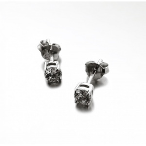 Boucles d'oreilles puces en argent 925 rhodié serties 4 griffes d'un oxyde de zirconium blanc.