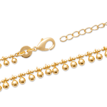Bracelet en plaqué or jaune 18 carats composé de petites breloques boules.