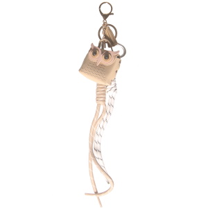 Porte clés en acier argenté et doré avec un mini sac en forme de hibou en polyuréthane et deux franges en textile.