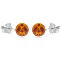 Boucles d'oreilles puces en argent 925/000 rhodié surmontées d'une véritable perle d'ambre.